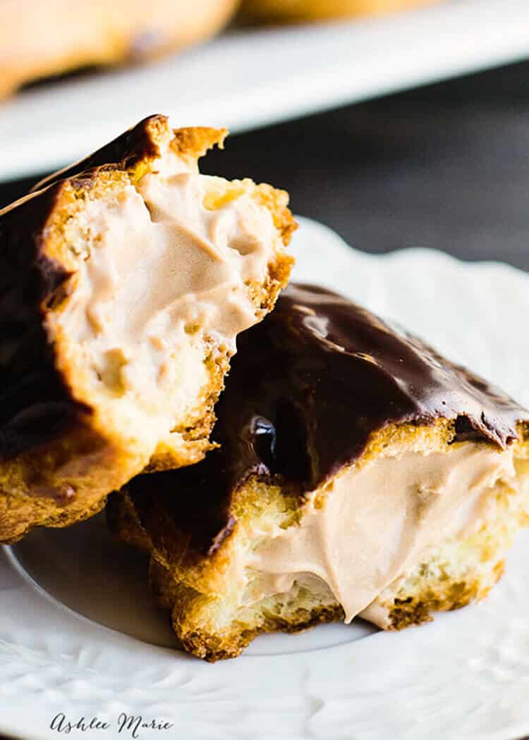a rich chocolate pasty cream filling is the perfect center for these homemade eclairs topped with a ganache icing - recipe and video tutorial