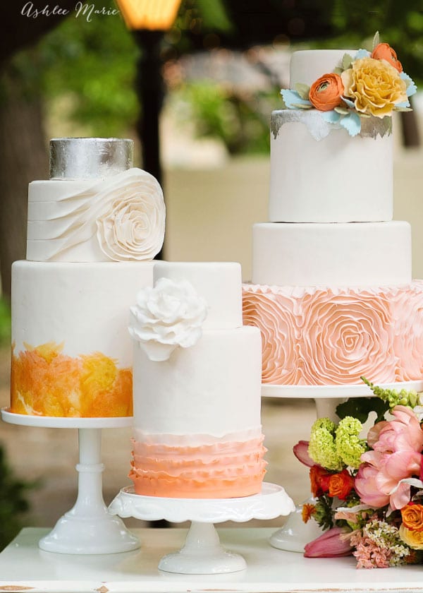it doesn't get much more stunning at a wedding that a trio of cakes that bring out the wedding colors, flowers and stunning details